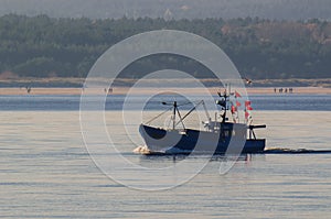 FISHING BOAT, SEAGULL AND PEOPLE ON THE BEACH