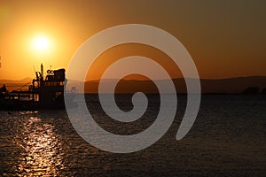 Fishing boat silhouette at sunset