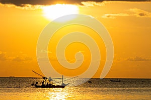 Fishing boat silouhette at sunset