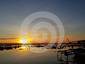 fishing boat stranded on Namosin beach When the sea water recedes. East Nusa Tenggara.