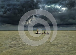 The fishing boat struggles for a life in a storm at Buriganga river, Bangladesh.