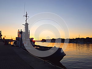 Fishing boat in sunset in the harbor