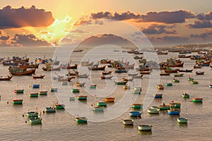 Fishing boat in sunset sky with hundreds of boats anchored to avoid storms, old Vietnamese boat for fishing on the beach fishing