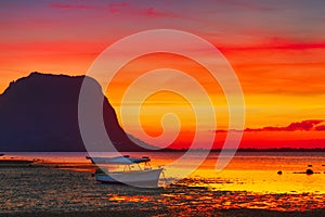 Fishing boat at sunset time. Le Morn Brabant on background.