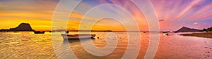 Fishing boat at sunset time. Le Morn Brabant on background. Panorama