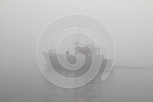 Fishing boat in thick fog