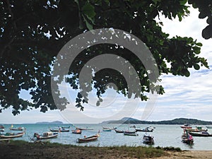 Fishing boat with tree at Rawai beach at phuket