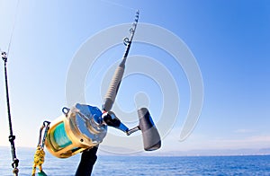 Fishing boat trolling in ocean with golden reel