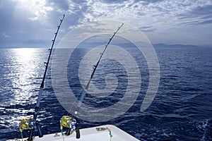 Fishing boat trolling with two rods and reels