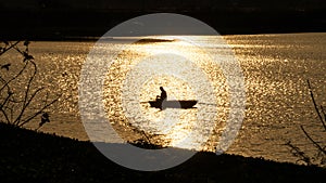 Fishing from a boat in the twilight