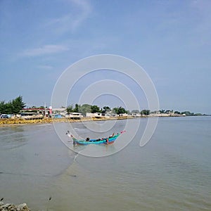 Fishing boat with two fishermen who have just returned from fishing.