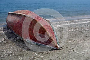 Fishing boat upside down, on the beach