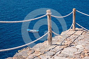 Fishing boat viewed from above in a beautiful blue sea