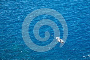 Fishing boat viewed from above in a beautiful blue sea