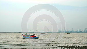 Fishing boats abstain from catching fish at sea cause storm and low tide