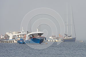 Fishing boats anchored in foggy weather