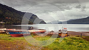 Fishing boats on the beach of Puyuhuapi Fjord, Patagonia, Chile, Pacific Ocean photo