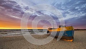 Fishing boats on the beach during a storm