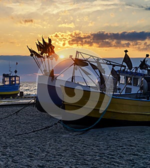 Fishing boats on the beach at sunset: Baltic Sea, Western Pomerania, Poland, Europe