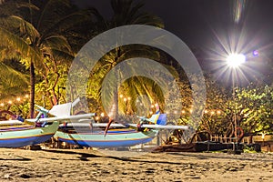 Fishing boats on the beach of tropical island Bali at night, Indonesia.