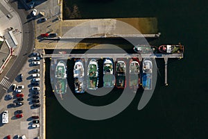 Fishing boats at the berths in the seaport, aerial view photo