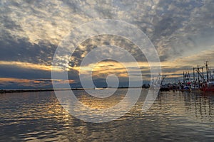 Fishing boats and boats are on the pier at the end of the day in