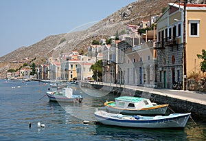 Fishing Boats and Colorful Greek Homes by The Sea. July 14,2013 in Symi, Greece