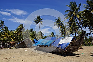 fishing boats covered with sailcloth on the beach