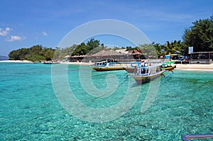 Fishing boats on crystal clear turquoise water photo