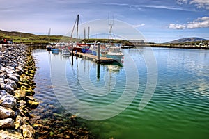 Fishing boats in Dingle harbor in summer, Ireland.