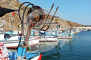 Fishing boats docked by the mountain