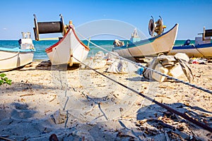 Fishing boats with equipment for angling are placed on the beach