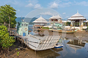 Fishing boats and ferry moored on the coast in Fishing Village o