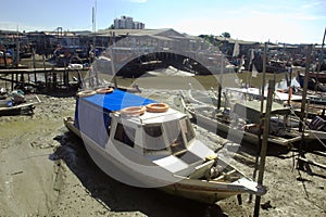 Fishing boats in fishing village during low tide