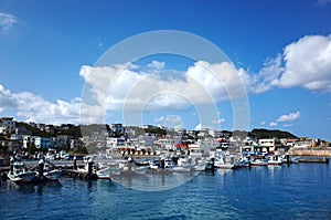 Fishing boats float moored in Sarahama Port at Miyakojima, Okinawa, Japan