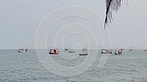 Fishing boats floating in the middle of the sea waiting to fish at Bang Lamung Sea, Chonburi