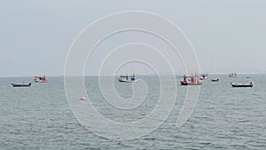 Fishing boats floating in the middle of the sea waiting to fish at Bang Lamung Sea, Chonburi