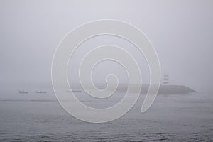 Fishing boats in the fog during toil