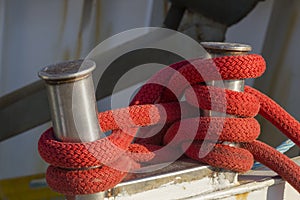 Fishing boats in harbor - bollard with red rope
