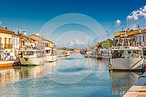 Fishing boats in harbor channel in Italy