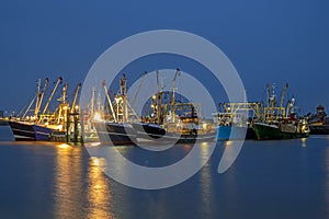 Fishing boats in the harbor from Lauwersoog in Netherlands at night