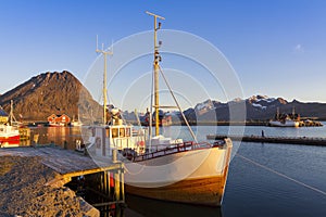 Fishing boats in harbor at midnight sun in Northern Norway, Lofoten Island, Ramberg, Norway photo