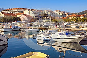 Fishing boats in harbor. Marina Kalimanj in Tivat city on sunny winter day. Montenegro