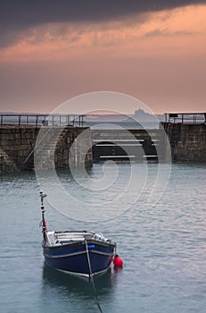 Fishing boats in harbour at sunrise