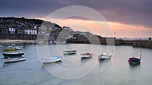 Fishing boats in harbour at sunrise