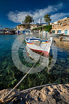 Fishing boats in harbour in fishing village of Mandrakia, Milos island, Greece