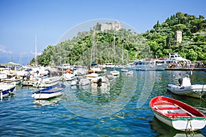 Fishing boats, luxury yachts and ferries with tourists at  picturesque harbor in Portofino, Liguria, Italy