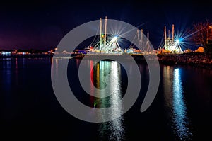 Fishing boats in marina at night