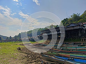 Fishing boats are moored on the edge of a reservoir