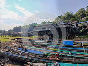 Fishing boats are moored on the edge of a reservoir